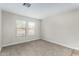 Bright bedroom with neutral paint and carpet plus two large windows at 415 W Midland Ln, Gilbert, AZ 85233
