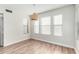 Bedroom with hardwood floors, woven light fixture, and bright windows at 415 W Midland Ln, Gilbert, AZ 85233