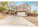 Two-story home boasts a spacious driveway leading to a two-car garage and neutral paint at 415 W Midland Ln, Gilbert, AZ 85233