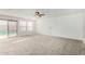 Bright, spacious living room with fan and sliding door leading to the backyard at 415 W Midland Ln, Gilbert, AZ 85233