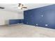 Spacious carpeted loft area featuring a ceiling fan and a stylish blue accent wall at 415 W Midland Ln, Gilbert, AZ 85233