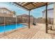 Inviting backyard pool with brick pavers, pergola, and secure fencing for safety and relaxation at 415 W Midland Ln, Gilbert, AZ 85233
