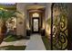 Inviting entryway featuring a wrought iron gate and pathway to the front door at 42406 N Long Cove Way, Anthem, AZ 85086