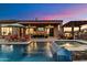 Evening view of a refreshing pool and spa with a cascading waterfall at 42406 N Long Cove Way, Anthem, AZ 85086