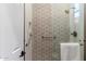 Elegant shower with patterned tile and glass enclosure at 42406 N Long Cove Way, Anthem, AZ 85086