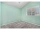 Light green bedroom with grey carpet, window blinds, and a closet at 441 S Maple -- # 13, Mesa, AZ 85206