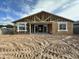Unfinished home back featuring wood frame, windows, sliding glass door, and sandy backyard at 5510 W Paseo Way, Laveen, AZ 85339