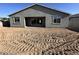 Home's backyard and exterior, showcasing ample space for landscaping and outdoor activities at 5510 W Paseo Way, Laveen, AZ 85339
