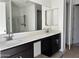 Bathroom showcasing double sinks, framed mirror, and under-sink storage at 5510 W Paseo Way, Laveen, AZ 85339