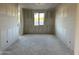 Unfinished bedroom with white drywall, a large window and doorway at 5510 W Paseo Way, Laveen, AZ 85339