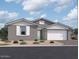 One-story home with gray siding, white garage door, and landscaping at 5510 W Paseo Way, Laveen, AZ 85339