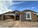 Construction progress of an exterior elevation featuring a two-car garage and modern architectural design at 5510 W Paseo Way, Laveen, AZ 85339