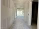 Bright hallway with white walls leading to a living area with sliding glass doors to a patio at 5510 W Paseo Way, Laveen, AZ 85339