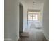 Hallway leading to sliding glass doors and a bright, spacious room with tile flooring at 5510 W Paseo Way, Laveen, AZ 85339
