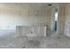 Unfinished kitchen with white drywall, concrete floors and partial island at 5510 W Paseo Way, Laveen, AZ 85339
