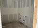 Unfinished laundry room with plumbing and electrical boxes, and white drywall at 5510 W Paseo Way, Laveen, AZ 85339