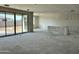 Unfinished living room with sliding glass doors leading to backyard, awaiting transformation into cozy haven at 5510 W Paseo Way, Laveen, AZ 85339