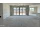 Spacious living room with white drywall and sliding glass doors leading to backyard at 5510 W Paseo Way, Laveen, AZ 85339