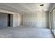Large, bright living area with walls ready for personalization and sliding doors to a future patio at 5510 W Paseo Way, Laveen, AZ 85339