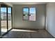 Room with tile floors, window, and sliding glass door access to back yard at 5510 W Paseo Way, Laveen, AZ 85339