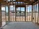 Framed interior with a view through the window and sliding glass doors, showcasing outdoor light at 5510 W Paseo Way, Laveen, AZ 85339