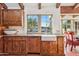 Bright kitchen with white farmhouse sink and wood cabinets at 6915 E Gary Rd, Scottsdale, AZ 85254