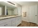 Bathroom boasts double vanity with granite countertop and updated flooring at 728 E Payton St, San Tan Valley, AZ 85140