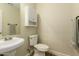 Clean bathroom with pedestal sink and linen storage at 728 E Payton St, San Tan Valley, AZ 85140