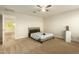 Well-lit bedroom with a bed, a door to another room and a view into another room at 728 E Payton St, San Tan Valley, AZ 85140