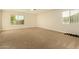 Spacious carpeted bedroom with large window and ceiling fan at 728 E Payton St, San Tan Valley, AZ 85140