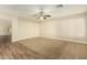 Living room features hardwood and carpeted floors, and a ceiling fan at 728 E Payton St, San Tan Valley, AZ 85140