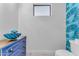 Stylish powder room with unique blue accent wall at 8 E Biltmore Est # 117, Phoenix, AZ 85016