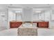 Spa-like bathroom with double vanities, a soaking tub, and a large mirror at 8 E Biltmore Est # 117, Phoenix, AZ 85016