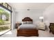 Well-lit bedroom with wooden furniture set, neutral tones, and calming ambiance at 8 E Biltmore Est # 117, Phoenix, AZ 85016