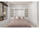 Cozy bedroom with built-in shelving, comfortable bed, and modern design elements at 8 E Biltmore Est # 117, Phoenix, AZ 85016