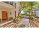 Brick pathway leads to a condo building entrance with a wooden door at 8 E Biltmore Est # 117, Phoenix, AZ 85016