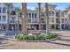 Eight Biltmore Estates building exterior, featuring palm trees and a circular driveway at 8 E Biltmore Est # 117, Phoenix, AZ 85016