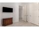 Bright hallway featuring paneled doors, stylish cabinet, and tiled flooring at 8 E Biltmore Est # 117, Phoenix, AZ 85016