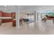 Open kitchen with granite countertops, dark wood cabinets, and island at 8 E Biltmore Est # 117, Phoenix, AZ 85016