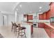 Kitchen features granite island with seating and dark wood cabinetry at 8 E Biltmore Est # 117, Phoenix, AZ 85016