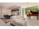 Bright, open living room with grand piano, modern lighting, and comfortable seating area at 8 E Biltmore Est # 117, Phoenix, AZ 85016