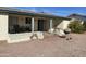 Charming covered back patio with grill, seating, potted plants, and neutral stucco exterior at 839 Leisure World --, Mesa, AZ 85206