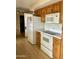 Bright kitchen with white appliances and ample wood cabinetry for storage at 839 Leisure World --, Mesa, AZ 85206