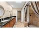 Elegant bathroom with dual sinks, granite countertops, and a walk-in shower at 8466 E San Benito Dr, Scottsdale, AZ 85258
