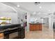 Open kitchen with island, granite countertops, and stainless steel appliances at 8466 E San Benito Dr, Scottsdale, AZ 85258