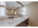 Modern bathroom featuring a double vanity with sleek black fixtures and a large, well-lit mirror at 8525 E Via De Los Libros --, Scottsdale, AZ 85258