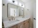 Bathroom featuring a double vanity with gold fixtures and a framed mirror at 8525 E Via De Los Libros --, Scottsdale, AZ 85258