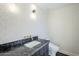 Stylish powder room featuring patterned wallpaper, dark vanity and modern sink at 8525 E Via De Los Libros --, Scottsdale, AZ 85258