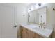 Bathroom featuring a double vanity with golden fixtures, a framed mirror, and a nearby door at 8525 E Via De Los Libros --, Scottsdale, AZ 85258