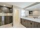 Modern bathroom features a double vanity, large mirrors, stylish lighting, and a glass enclosed shower at 8525 E Via De Los Libros --, Scottsdale, AZ 85258